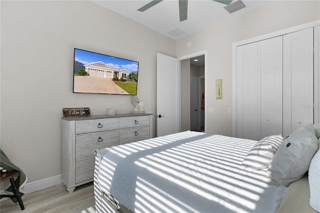 bedroom featuring a closet, light hardwood / wood-style floors, and ceiling fan