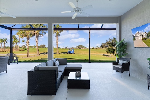 interior space featuring glass enclosure, ceiling fan, and an outdoor hangout area