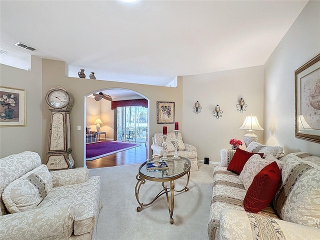 living room with ceiling fan and carpet flooring