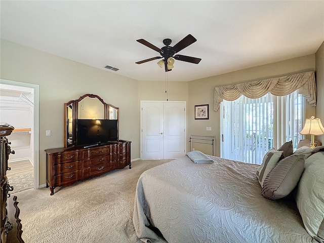 carpeted bedroom with ceiling fan and a closet