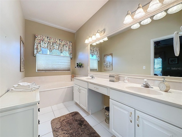 bathroom featuring plenty of natural light, vanity, a bath, and tile patterned flooring