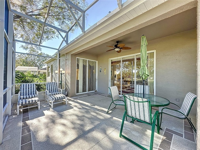 sunroom featuring ceiling fan