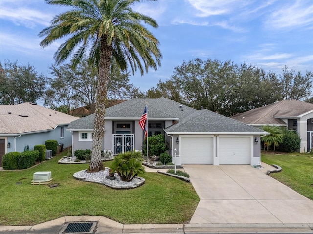 single story home featuring stucco siding, driveway, a front yard, and a garage