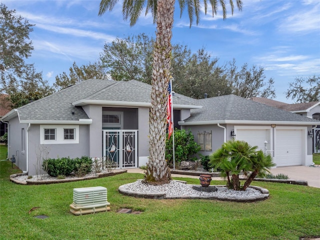 ranch-style home with stucco siding, a front lawn, a shingled roof, and a garage