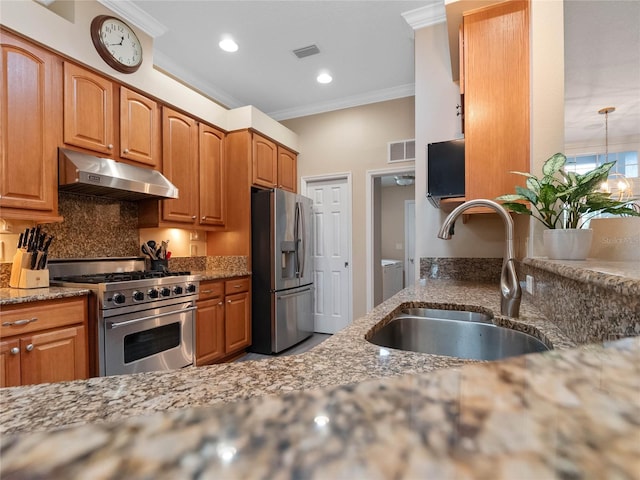 kitchen with visible vents, ornamental molding, under cabinet range hood, a sink, and stainless steel appliances