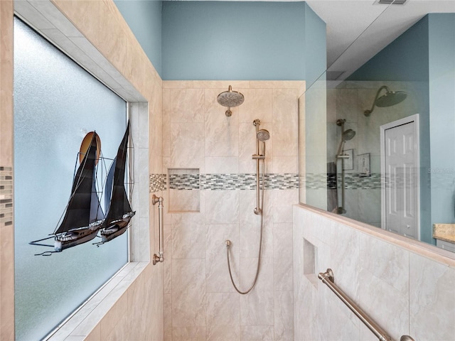 bathroom with a walk in shower and visible vents