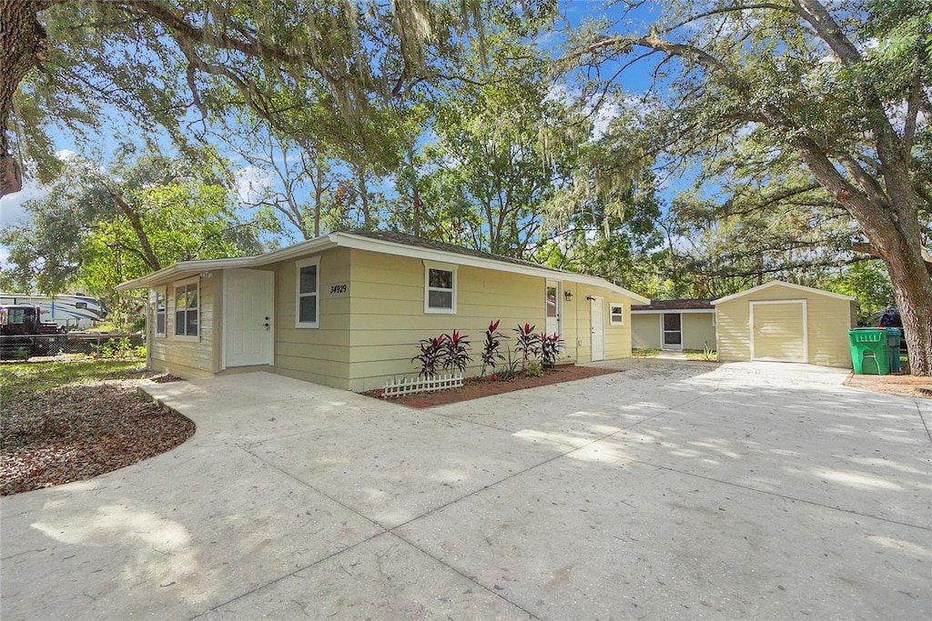 single story home with a shed