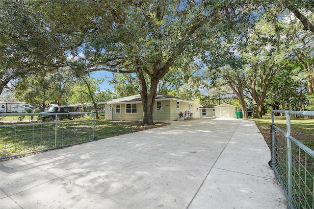 ranch-style home with an outbuilding, a front yard, and a garage