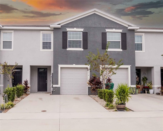 townhome / multi-family property featuring a garage