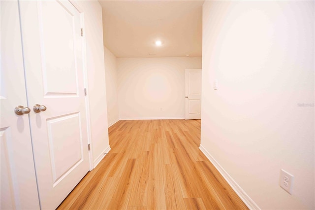 corridor with light wood-type flooring