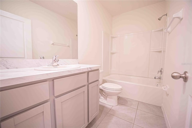 full bathroom with washtub / shower combination, vanity, tile patterned floors, and toilet