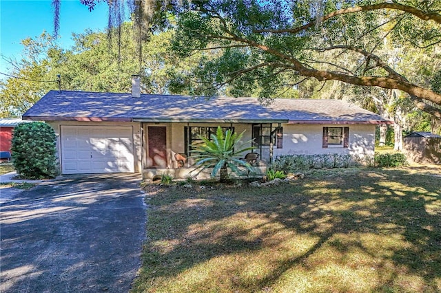 ranch-style house with a front lawn and a garage