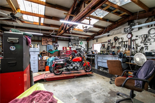 garage featuring a workshop area and ceiling fan