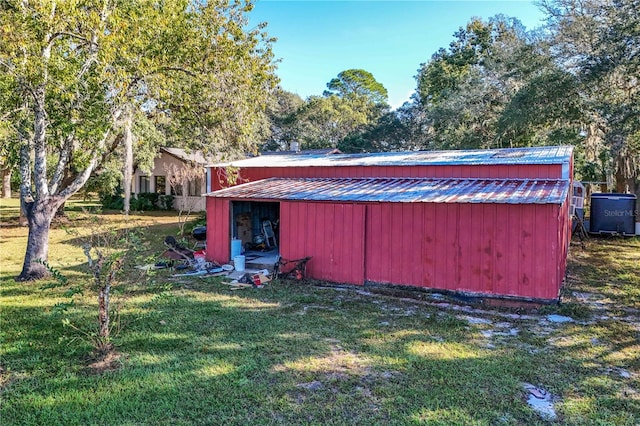 view of outbuilding with a lawn