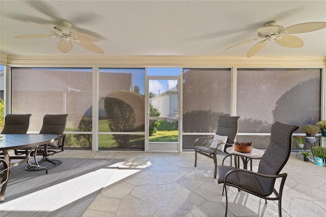 sunroom / solarium featuring ceiling fan