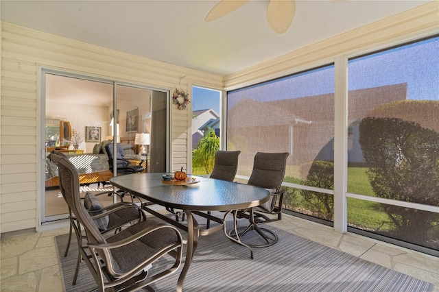 sunroom / solarium featuring ceiling fan