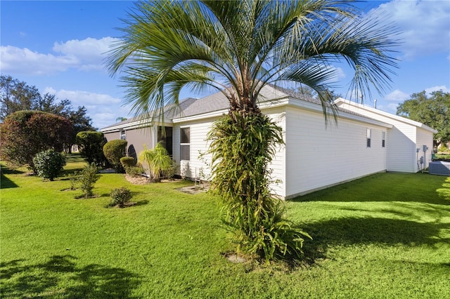 view of side of home featuring a lawn