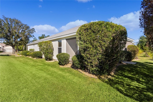 view of property exterior with a lawn