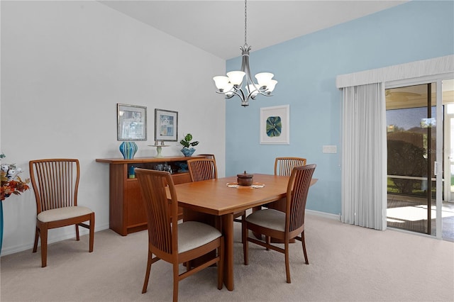 dining space with vaulted ceiling, light carpet, and an inviting chandelier