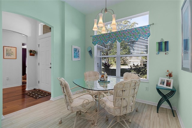 dining area with a notable chandelier and light wood-type flooring