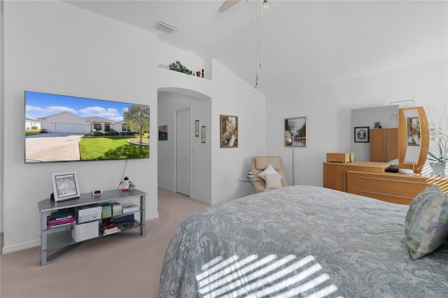 carpeted bedroom featuring ceiling fan and high vaulted ceiling