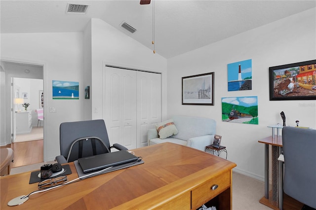 home office with light hardwood / wood-style floors, vaulted ceiling, and ceiling fan