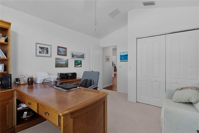 office space with light carpet and lofted ceiling