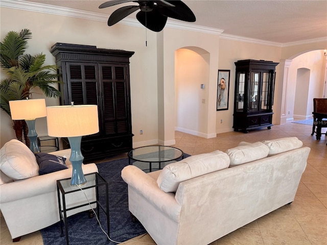 living room with light tile patterned floors, ceiling fan, and ornamental molding