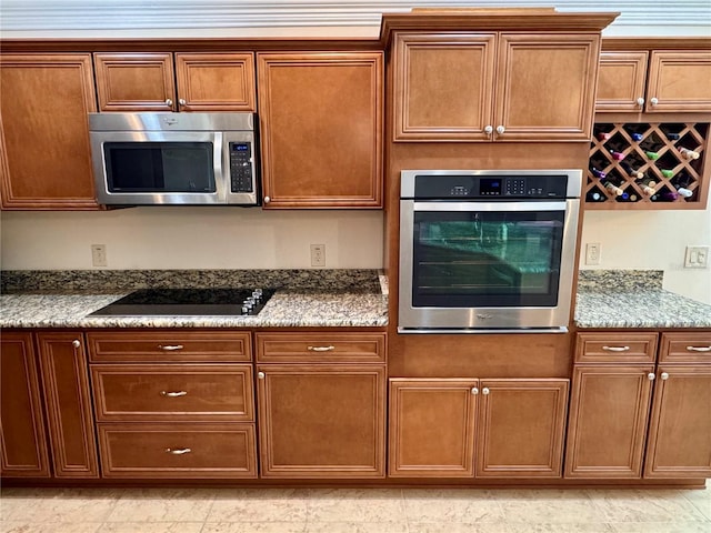 kitchen with stone counters and stainless steel appliances