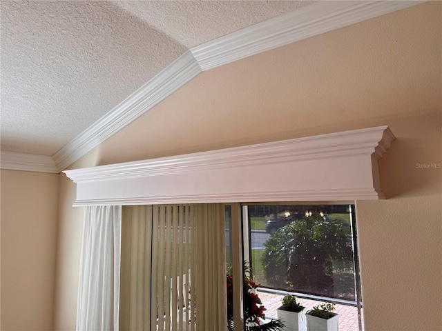 interior details featuring a textured ceiling and ornamental molding