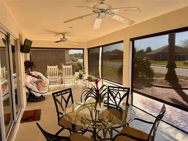 sunroom / solarium featuring ceiling fan