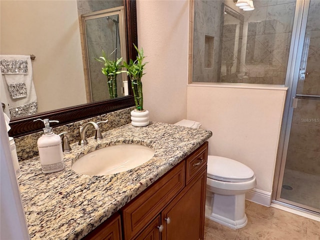 bathroom featuring tile patterned flooring, vanity, toilet, and walk in shower