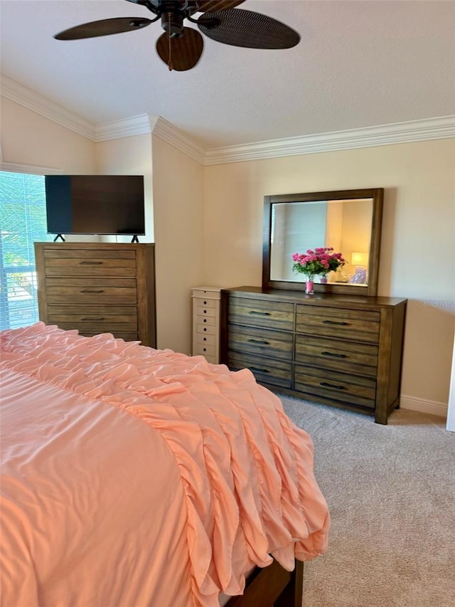 carpeted bedroom with ceiling fan and crown molding