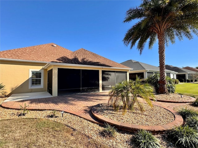 back of house with a sunroom and a patio