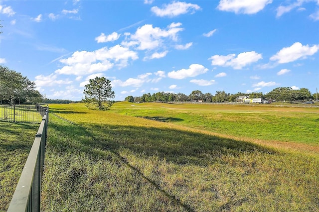 view of yard with a rural view and fence