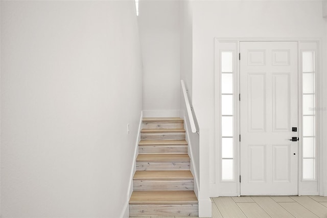 foyer entrance featuring light wood-style floors and stairs