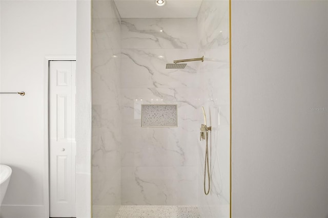 bathroom with a marble finish shower