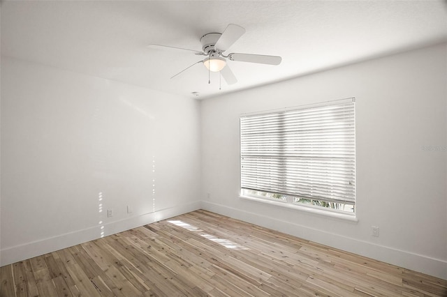 unfurnished room featuring wood-type flooring, baseboards, and a ceiling fan