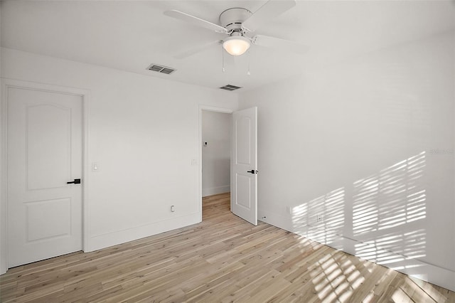 unfurnished bedroom with light wood-type flooring, baseboards, visible vents, and ceiling fan