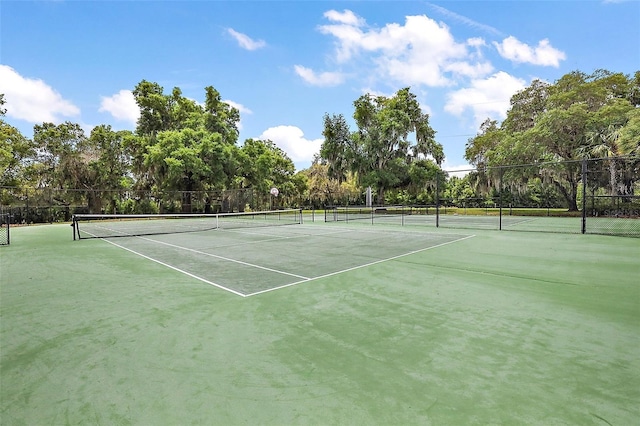 view of sport court featuring fence