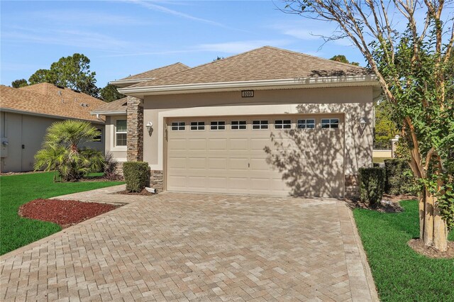 view of front of home with a front yard and a garage