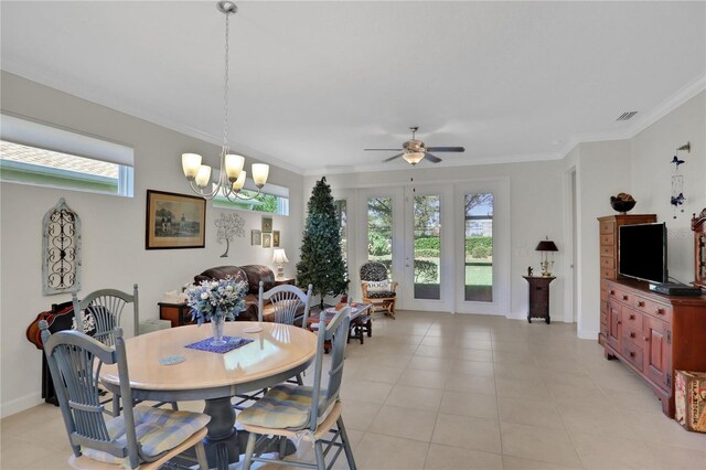 dining room featuring crown molding, plenty of natural light, light tile patterned flooring, and ceiling fan with notable chandelier