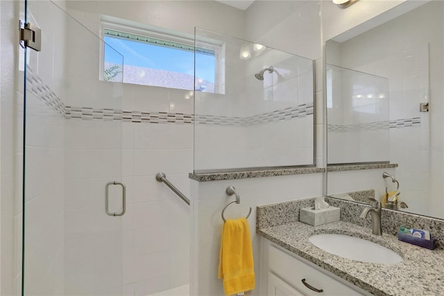 bathroom with vanity and a shower with shower door