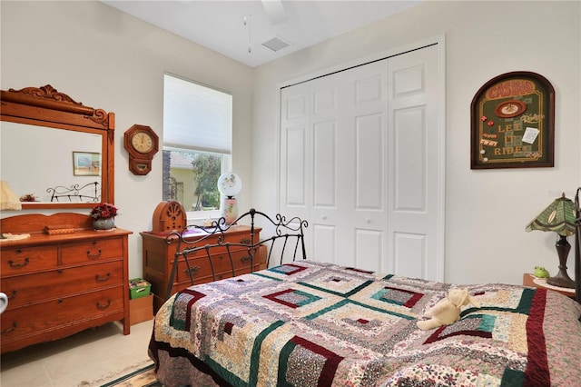 tiled bedroom featuring a closet and ceiling fan