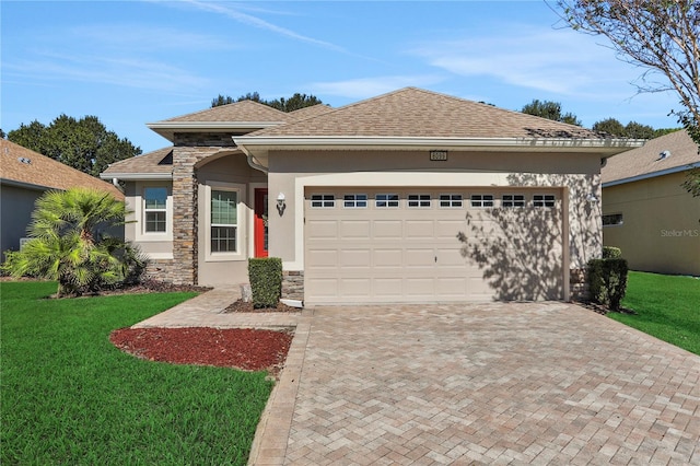 view of front of home featuring a front yard and a garage