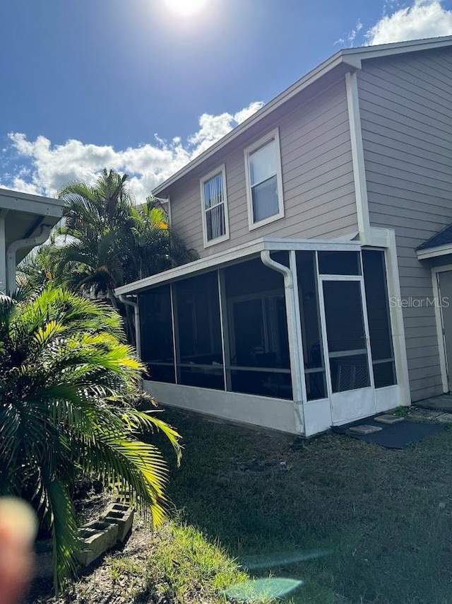 view of property exterior featuring a sunroom