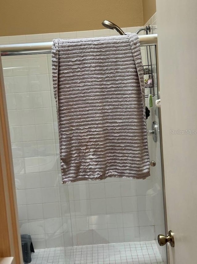 bathroom featuring a shower with door