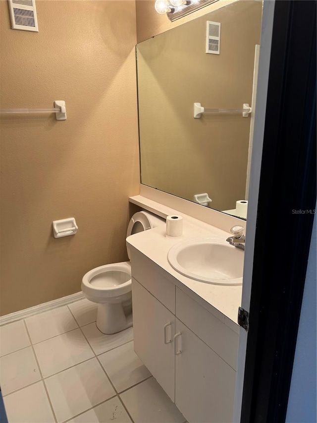 bathroom featuring visible vents, baseboards, toilet, tile patterned flooring, and vanity