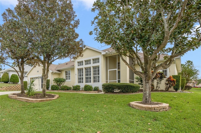 view of front of house featuring a front yard and a garage