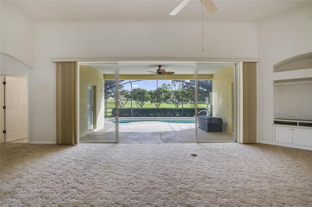 interior space featuring carpet and ceiling fan